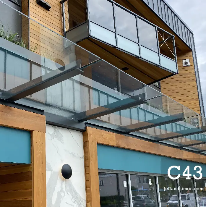 Custom metal balcony railing being installed on a Vancouver condo building
