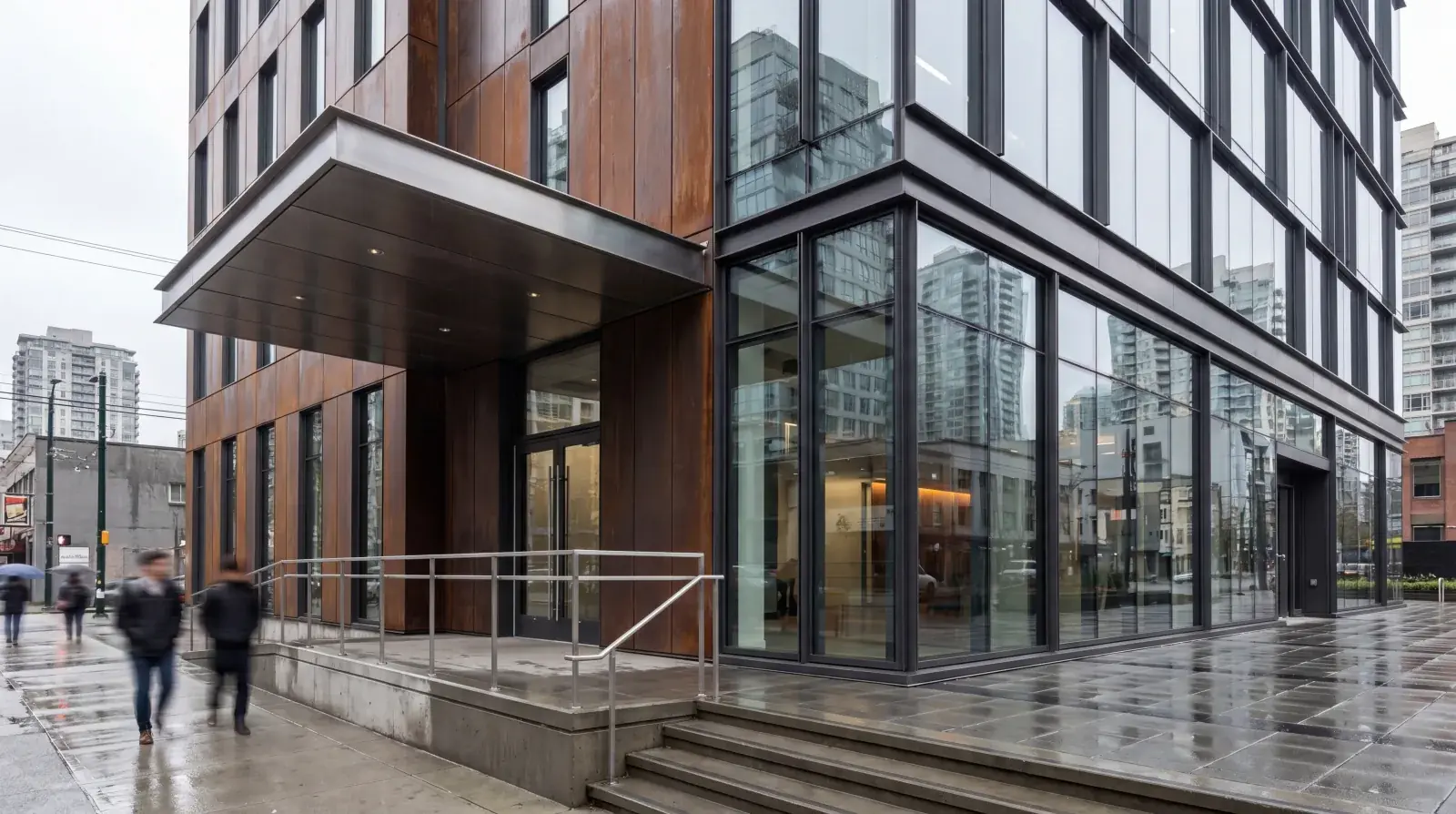 Modern commercial lobby with custom architectural steel staircase and glass railing system in Metro Vancouver