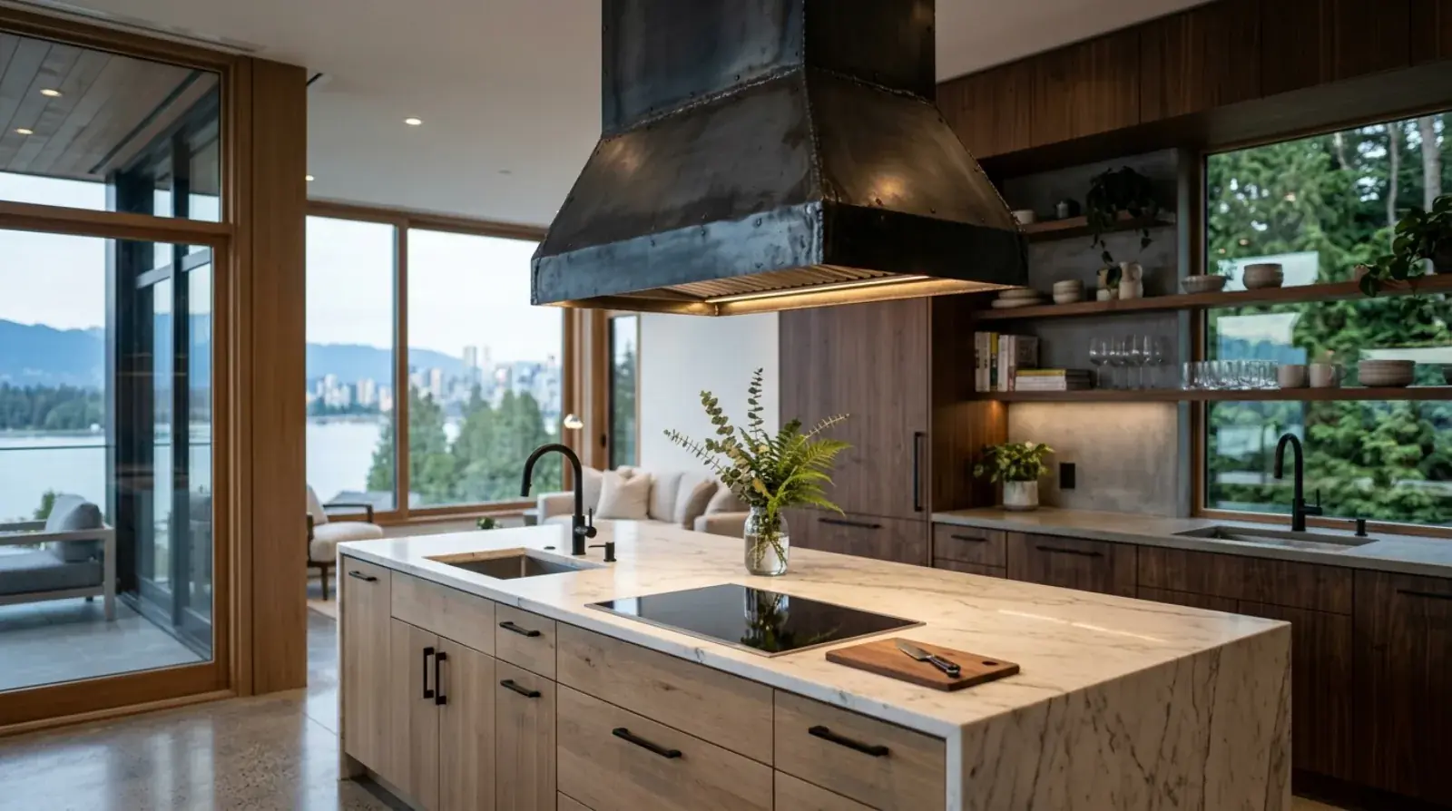 A custom brushed stainless steel range hood mounted over a kitchen island in a modern Vancouver home