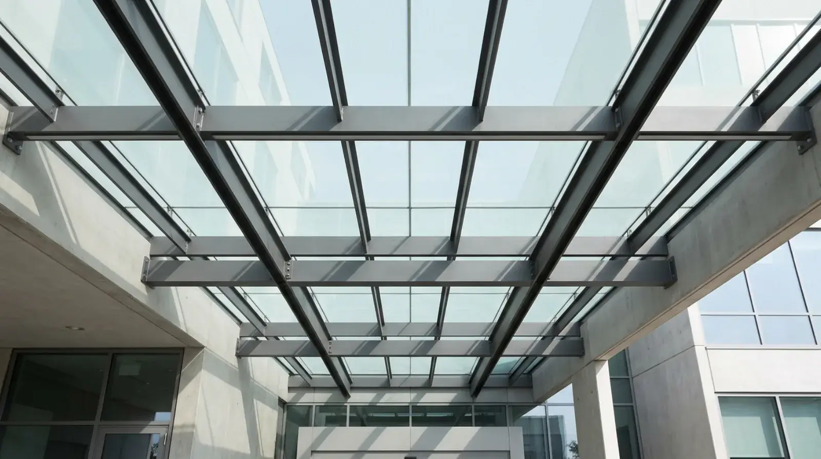 Laminated glass panels supported on a steel canopy frame above a commercial entrance in Vancouver