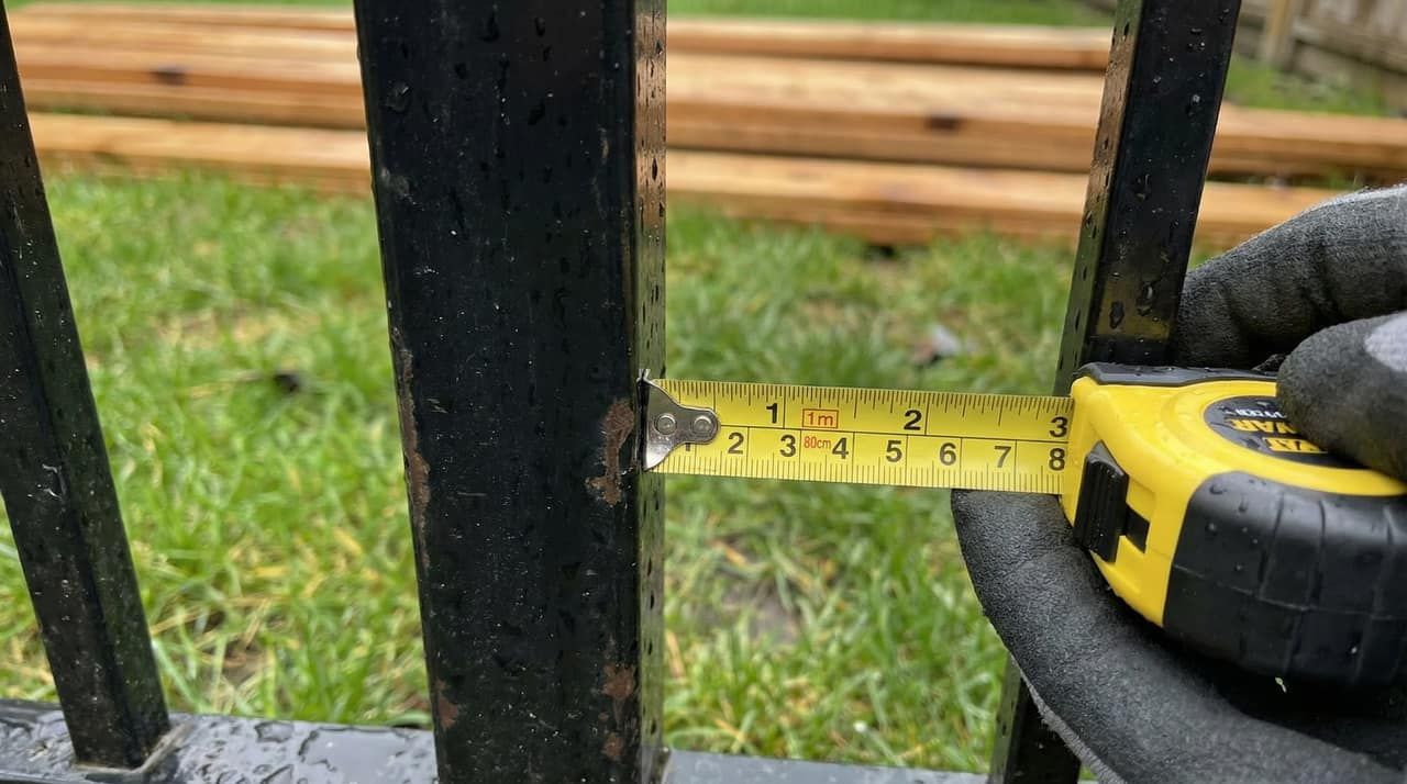 Tape measure showing fence height check at a Burnaby backyard installation