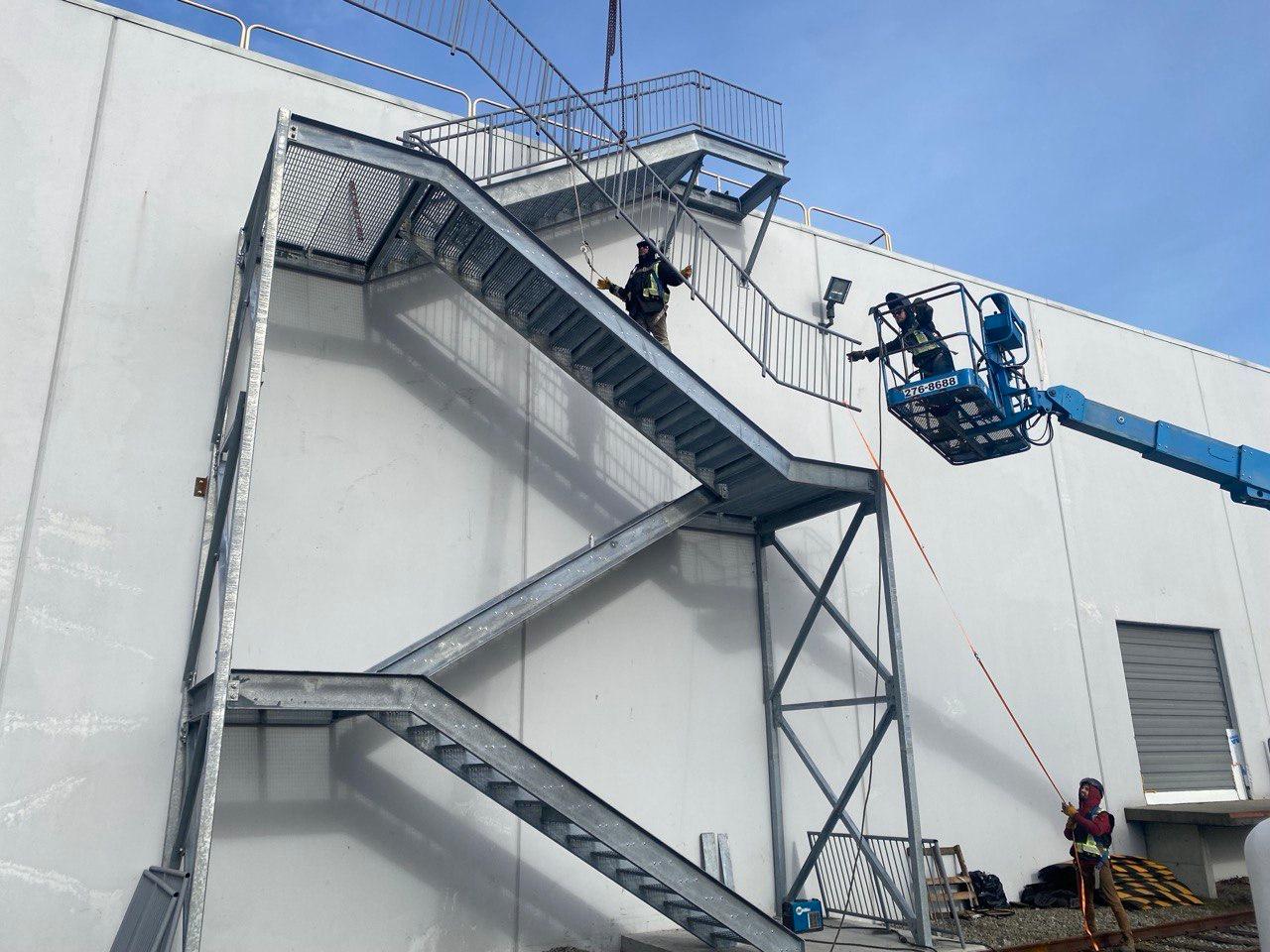 Multi-landing galvanized steel exterior egress staircase fabricated and installed by Jeff and Simon Ironworks on a commercial building in Burnaby, BC