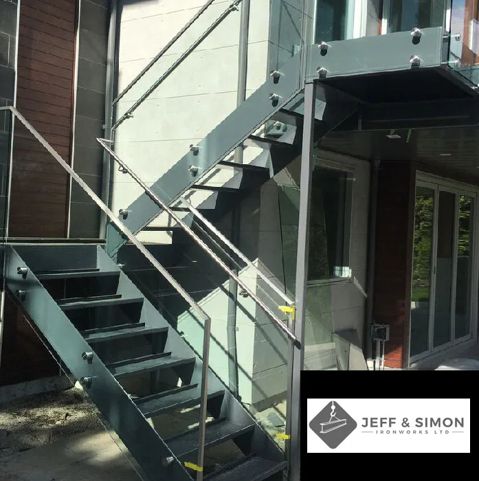 Exterior steel staircase with glass railing panels on a modern Vancouver commercial building