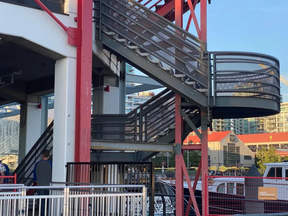 Curved steel staircase with metal railings at a waterfront commercial property in Vancouver