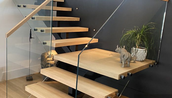 Custom floating staircase with oak treads, steel stringer, and glass railing in modern Vancouver home