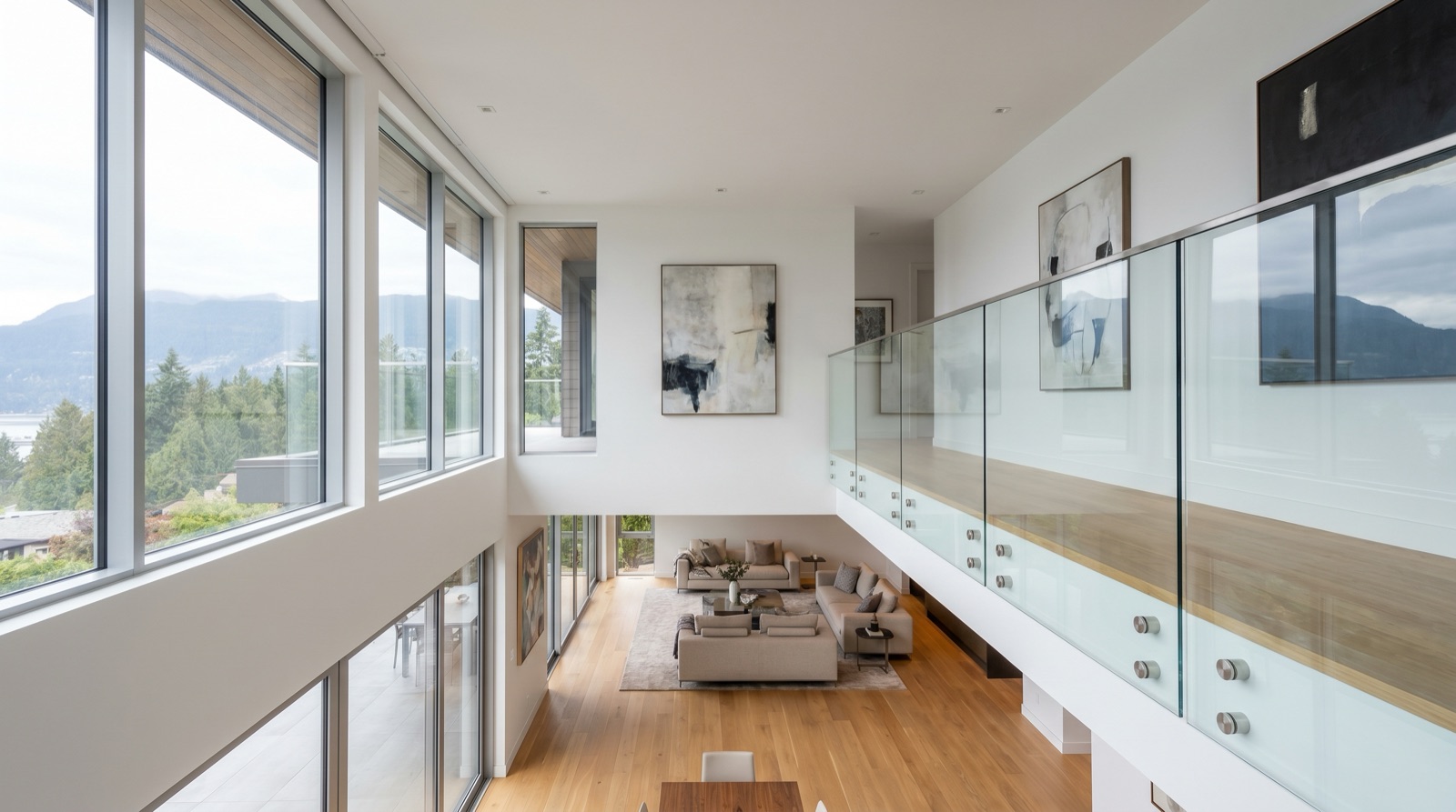 Frameless glass guardrail on a Vancouver balcony detailed to 2024 BC Building Code requirements, fabricated by Jeff and Simon Ironworks